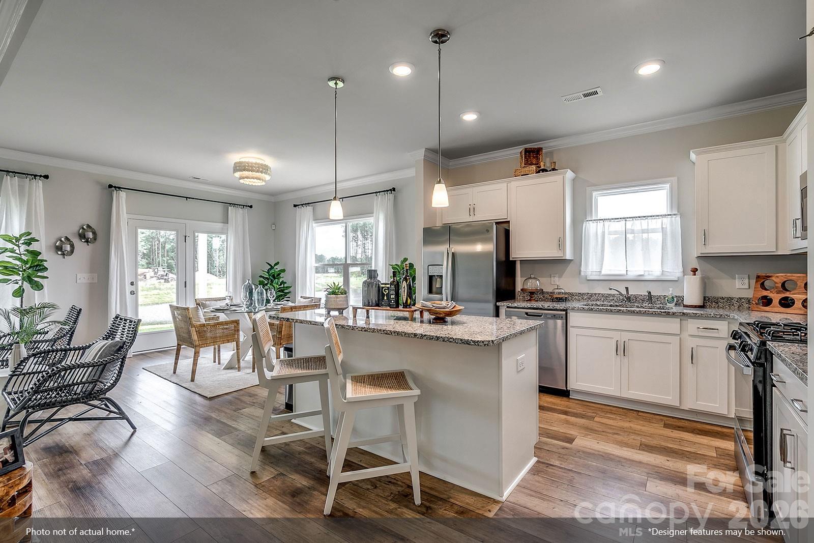 206 Rodeo Drive, Unit 25 Shelby, NC 28150 - Photo 4 of 9 a kitchen with a table chairs stove and cabinets