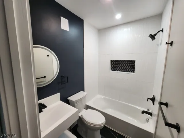 a bathroom with a toilet a sink and bathtub