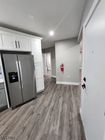 a view of a refrigerator in kitchen and wooden floor