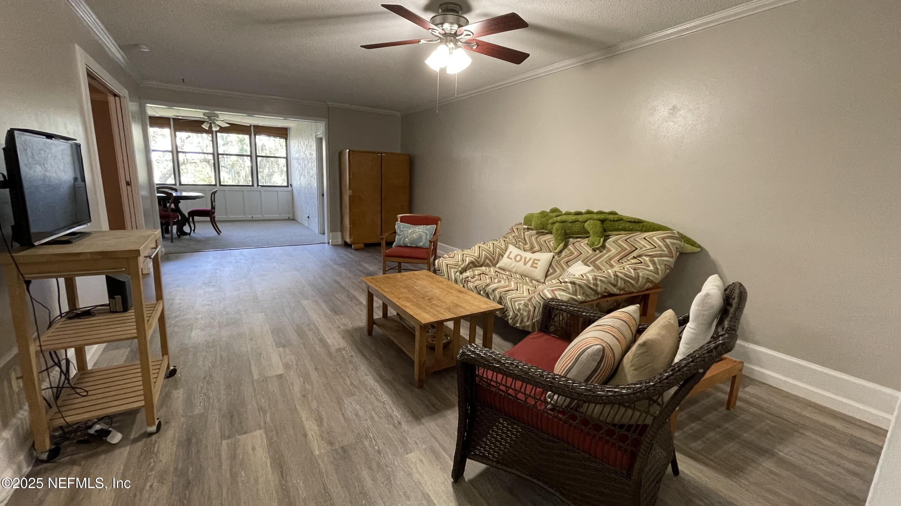 2510 Southwest 14th Drive Gainesville, FL 32608 - Photo 14 of 71 a living room with furniture and a flat screen tv
