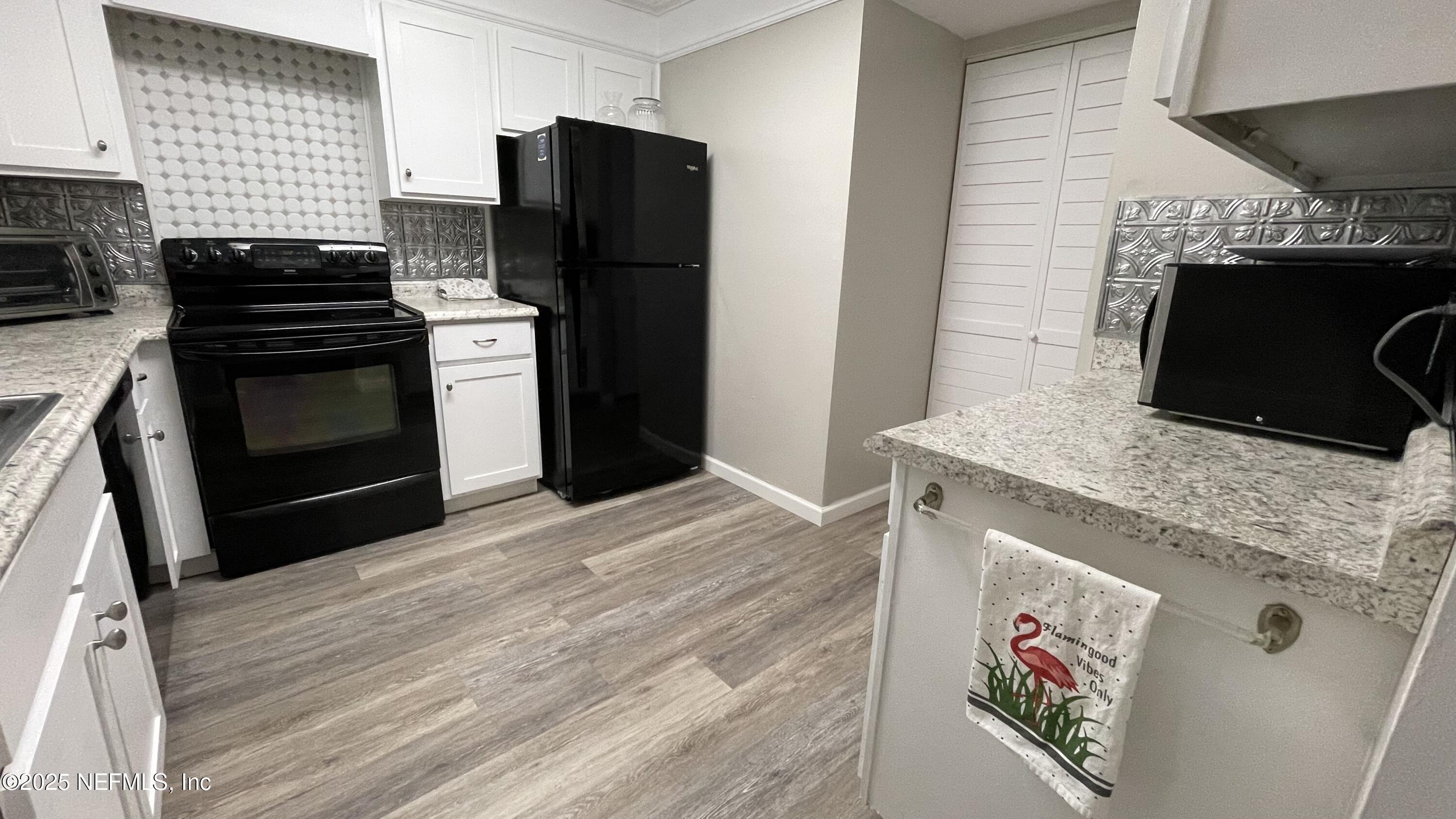 2510 Southwest 14th Drive Gainesville, FL 32608 - Photo 21 of 71 a kitchen with granite countertop a stove and a refrigerator