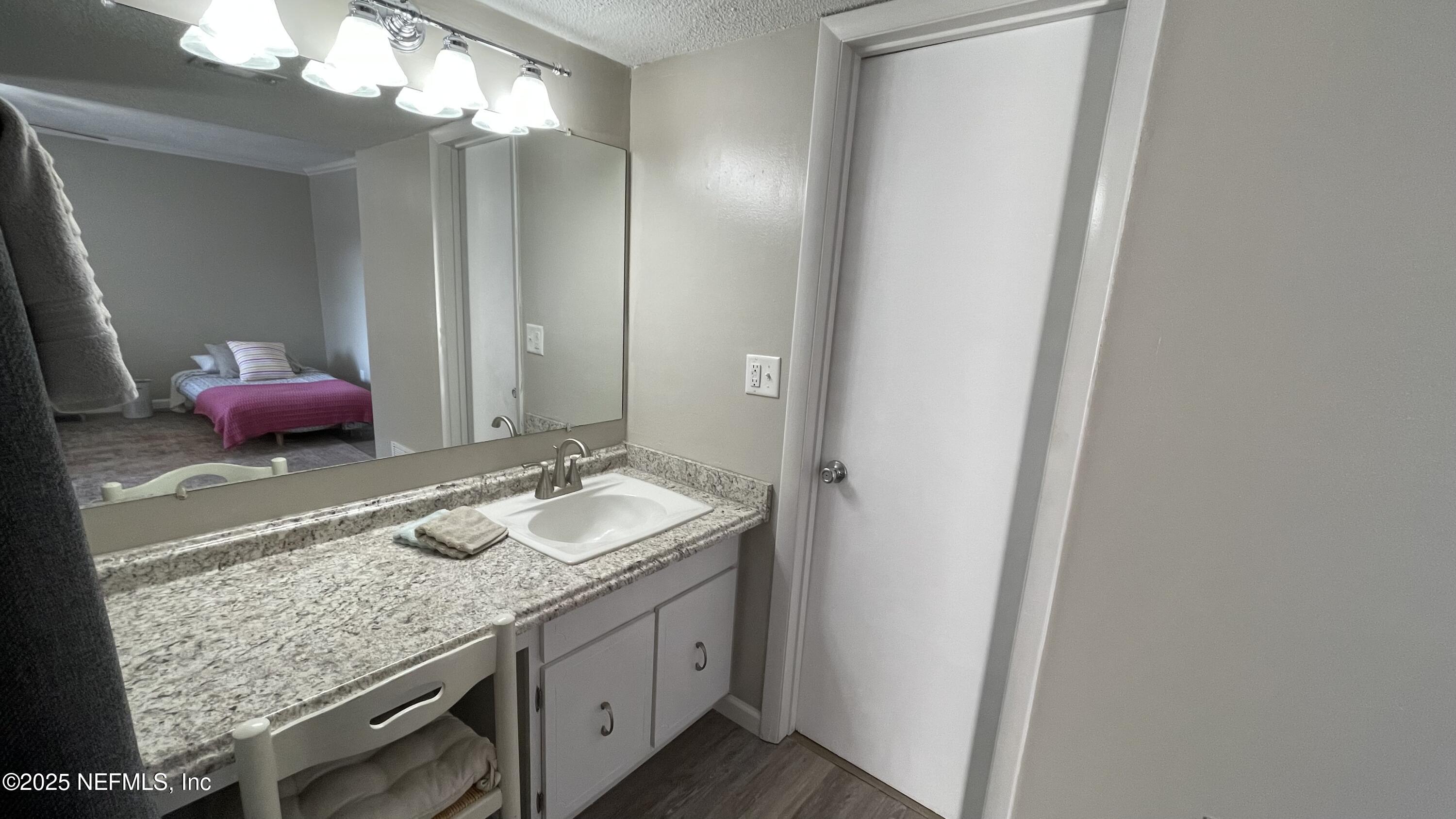 2510 Southwest 14th Drive Gainesville, FL 32608 - Photo 43 of 71 a bathroom with a granite countertop sink and a mirror