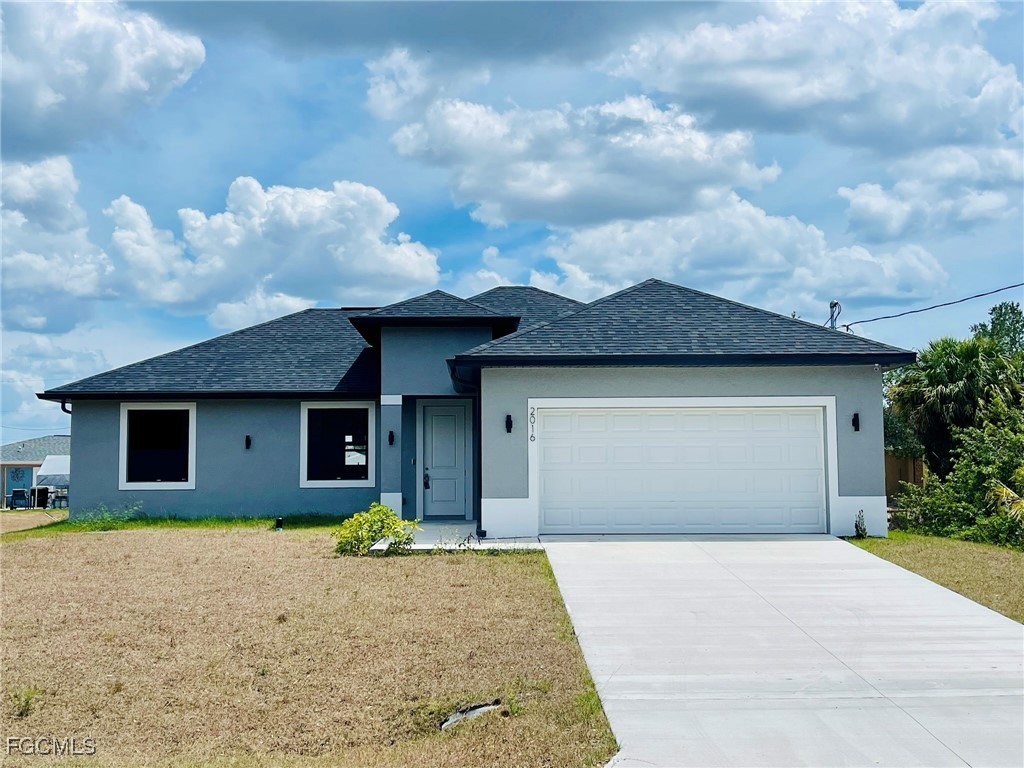 2016 Hercules Road LaBelle, FL 33935 - Photo 1 of 13 a front view of a house with a yard and garage