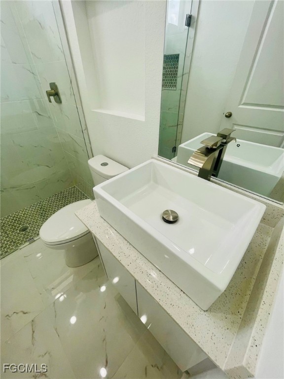 2016 Hercules Road LaBelle, FL 33935 - Photo 12 of 13 a bathroom with a sink a toilet and shower