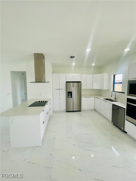 2016 Hercules Road LaBelle, FL 33935 - Photo 4 of 13 a large kitchen with stainless steel appliances granite countertop a large stove top oven a sink dishwasher and a refrigerator with wooden floor