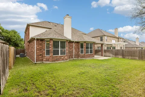 a view of a house with a backyard and a garden