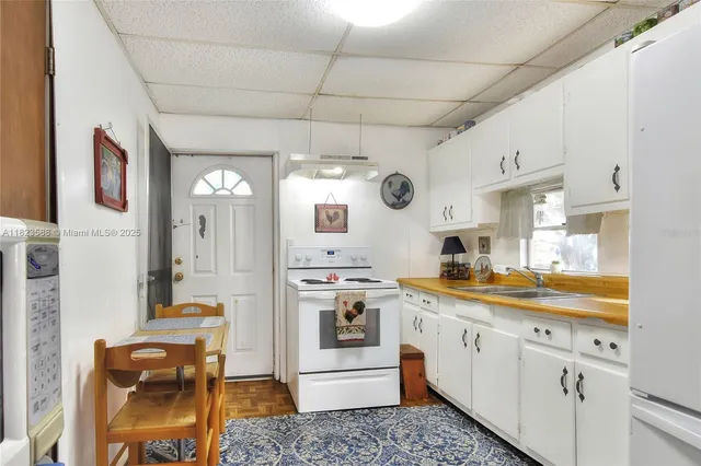 a kitchen with a stove a sink and a refrigerator