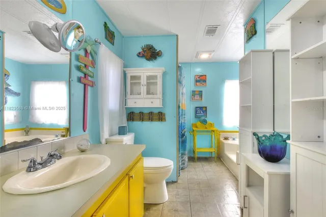 a bathroom with a sink a bathtub and a toilet