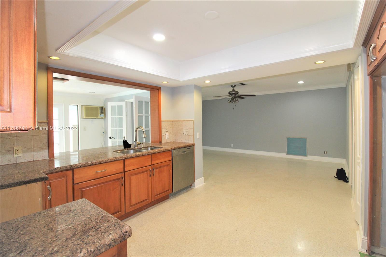 5261 Southwest 9th Street Plantation, FL 33317 - Photo 21 of 27 a large bathroom with a granite countertop sink a large mirror and a shower