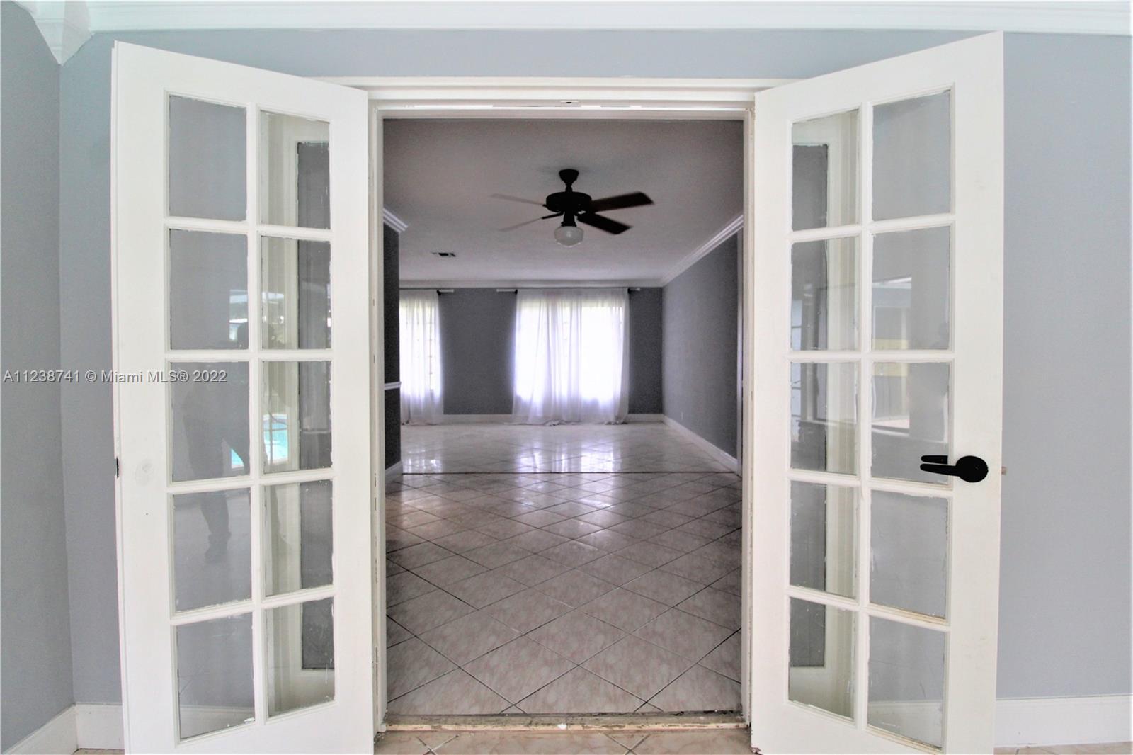 5261 Southwest 9th Street Plantation, FL 33317 - Photo 26 of 27 a view of a livingroom with a ceiling fan and window