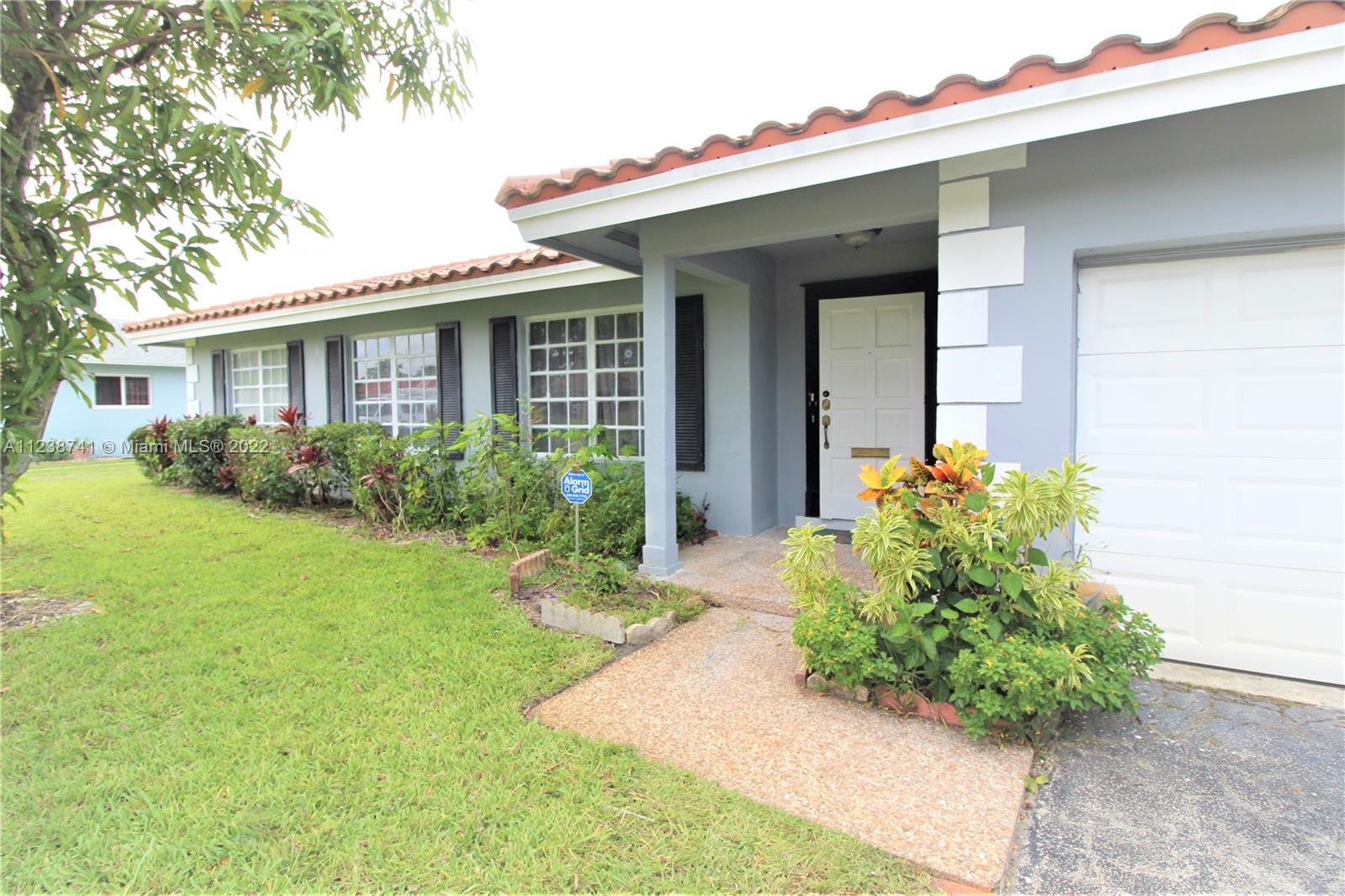 5261 Southwest 9th Street Plantation, FL 33317 - Photo 3 of 27 a front view of a house with garden