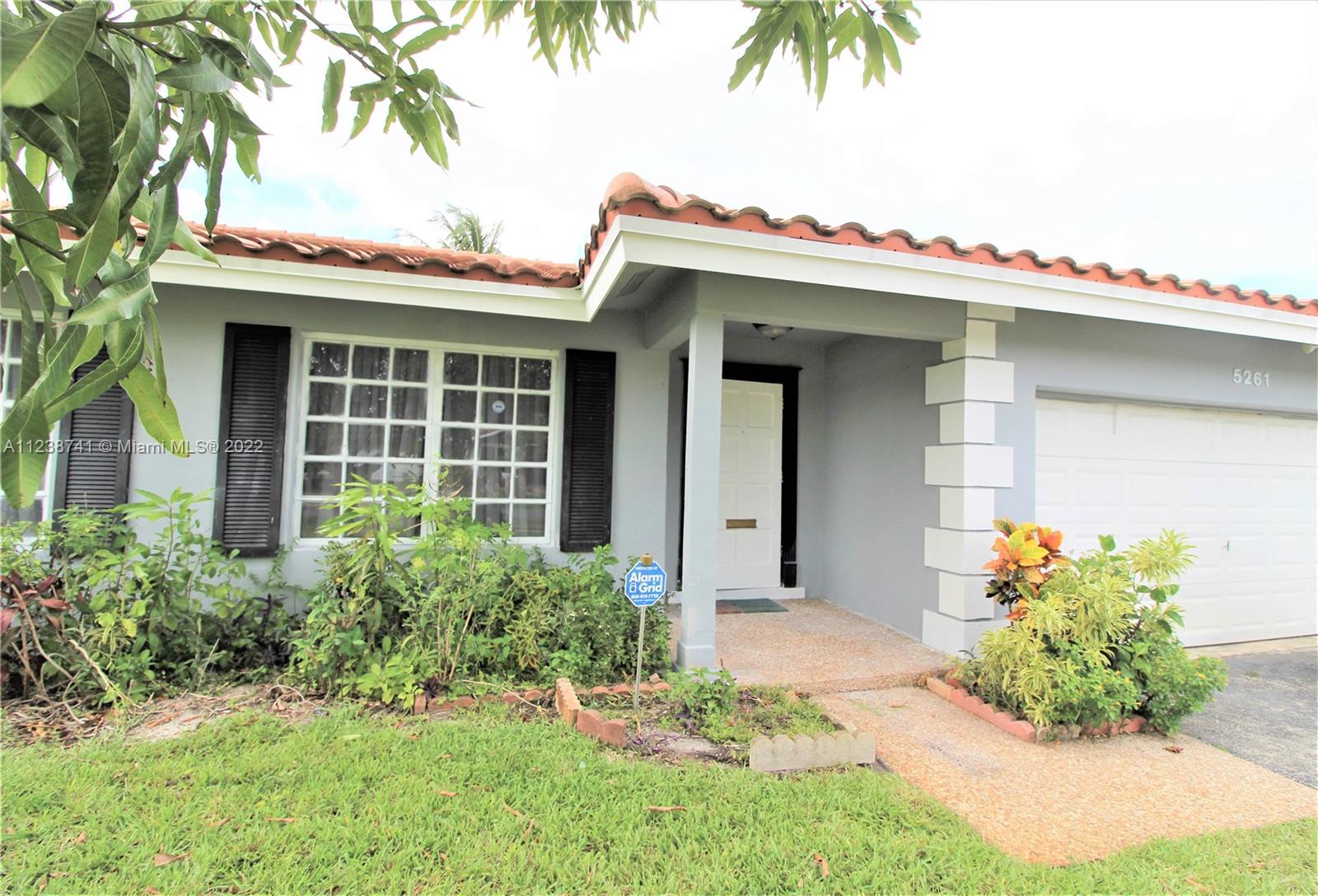 5261 Southwest 9th Street Plantation, FL 33317 - Photo 9 of 27 a front view of a house with a garden