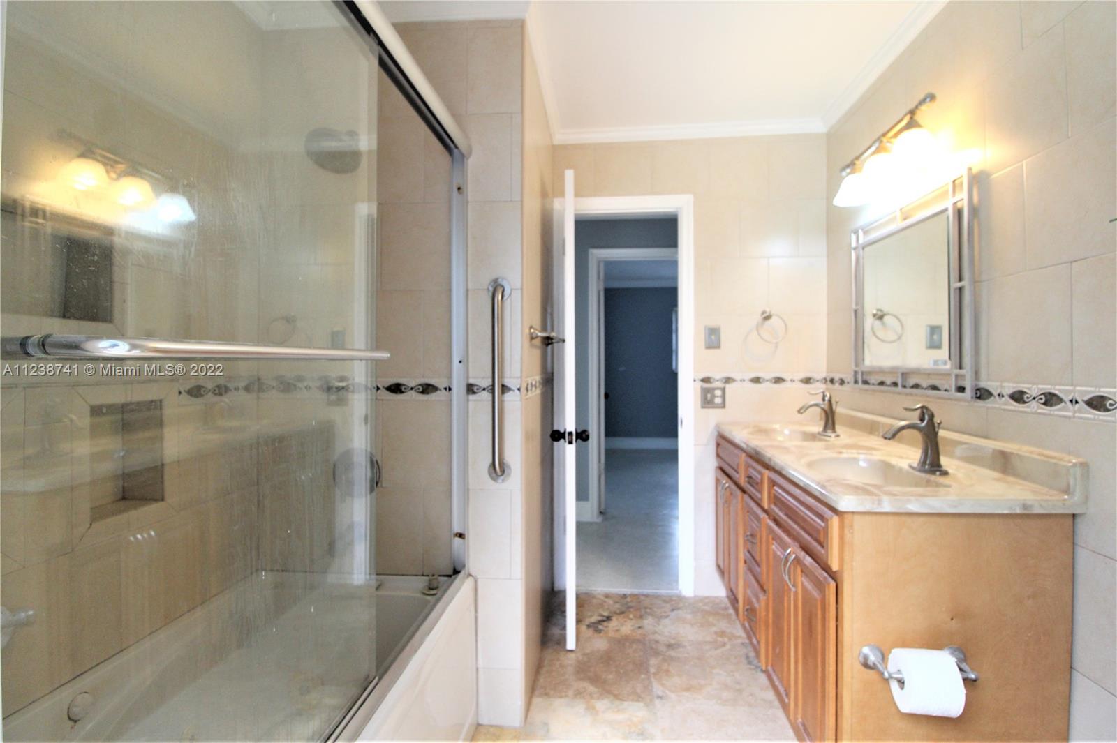 5261 Southwest 9th Street Plantation, FL 33317 - Photo 10 of 27 a bathroom with a sink and mirror