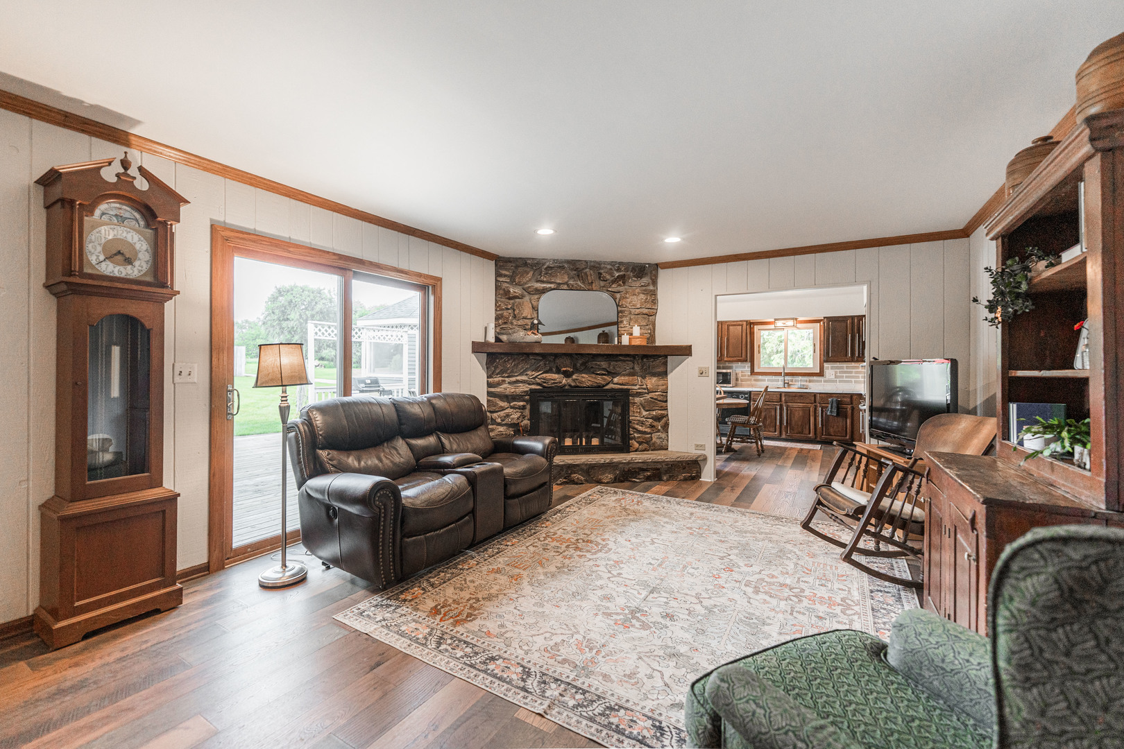 17751 Scott Road Hinckley, IL 60520 - Photo 17 of 72 a living room with furniture a fireplace a flat screen tv and windows