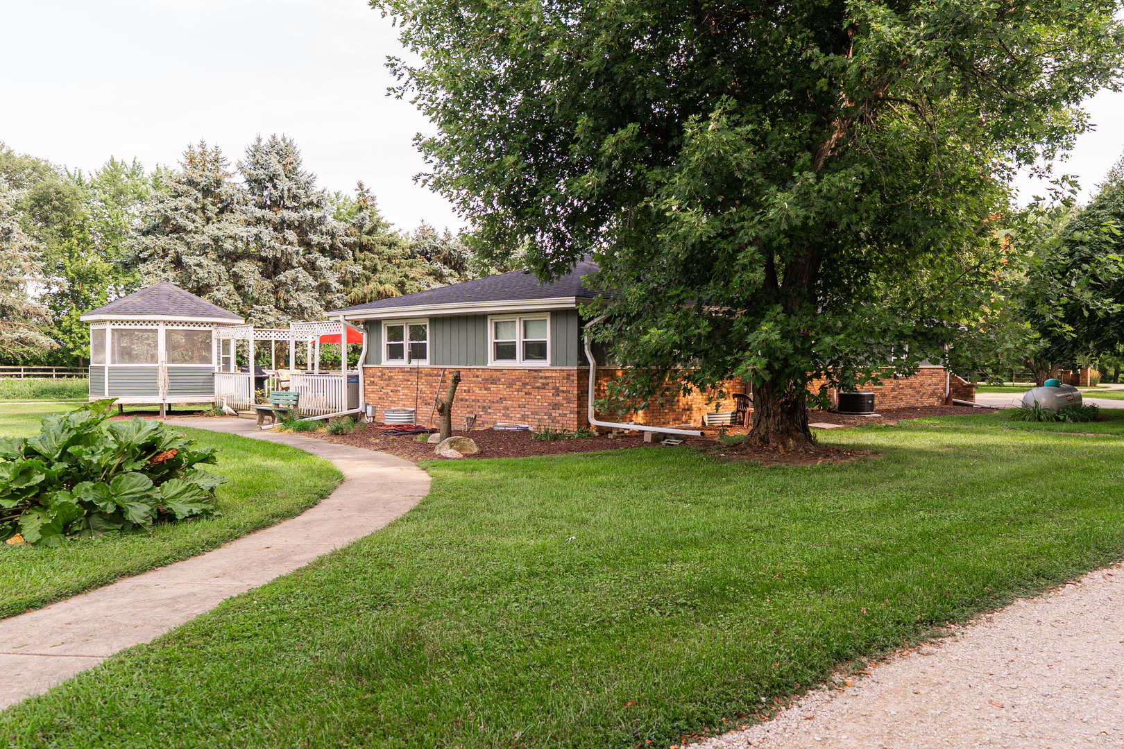 17751 Scott Road Hinckley, IL 60520 - Photo 39 of 72 a front view of a house with a garden and trees