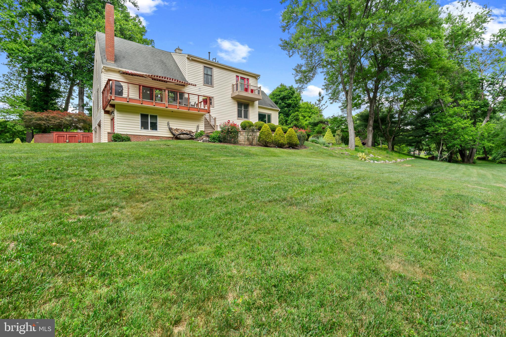 10821 Braeburn Road Columbia, MD 21044 - Photo 61 of 64 a view of a white house with a big yard and large trees