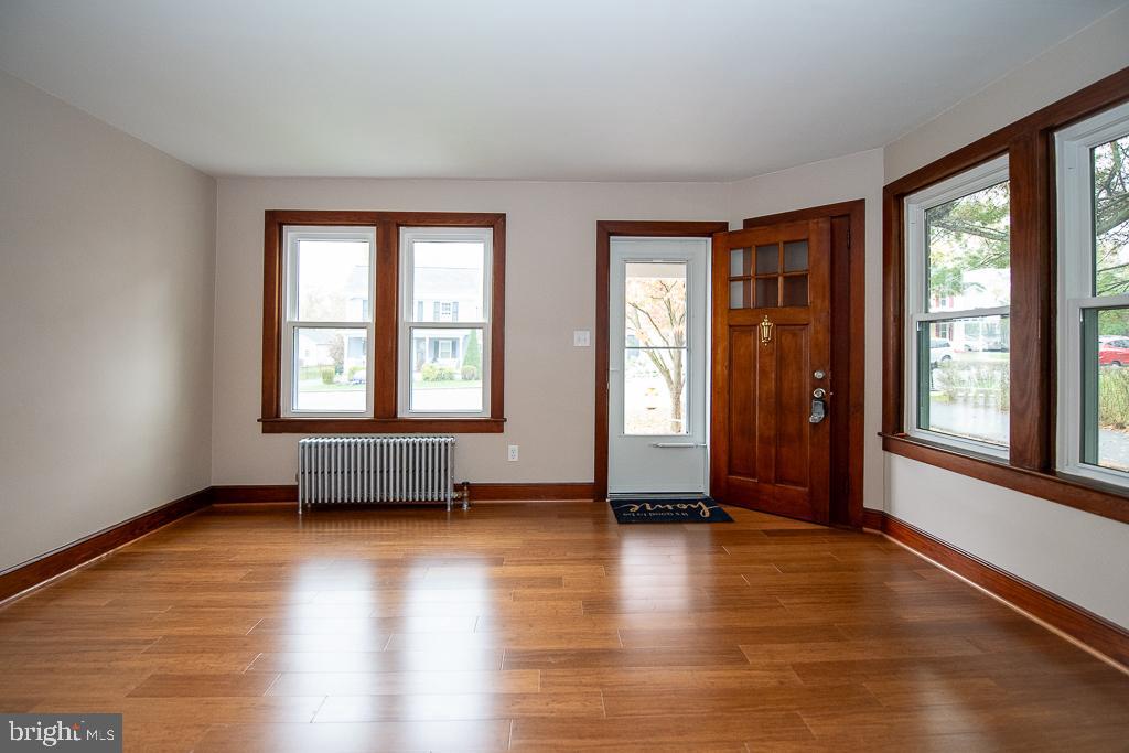 9 Fulton Avenue Walkersville, MD 21793 - Photo 9 of 28 a view of an empty room with glass door and wooden floor