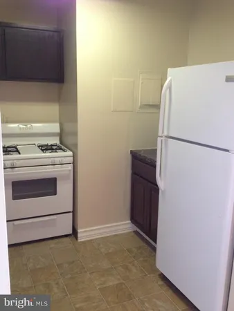 a kitchen with stainless steel appliances granite countertop a stove and a microwave