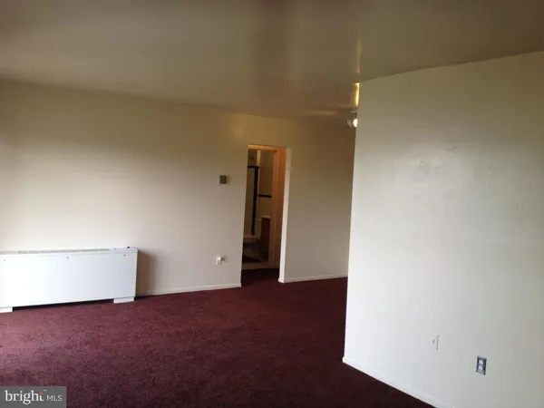 a view of an empty room and a window