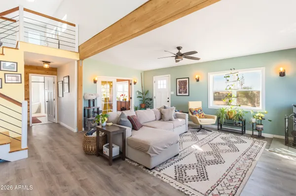a living room with furniture and wooden floor