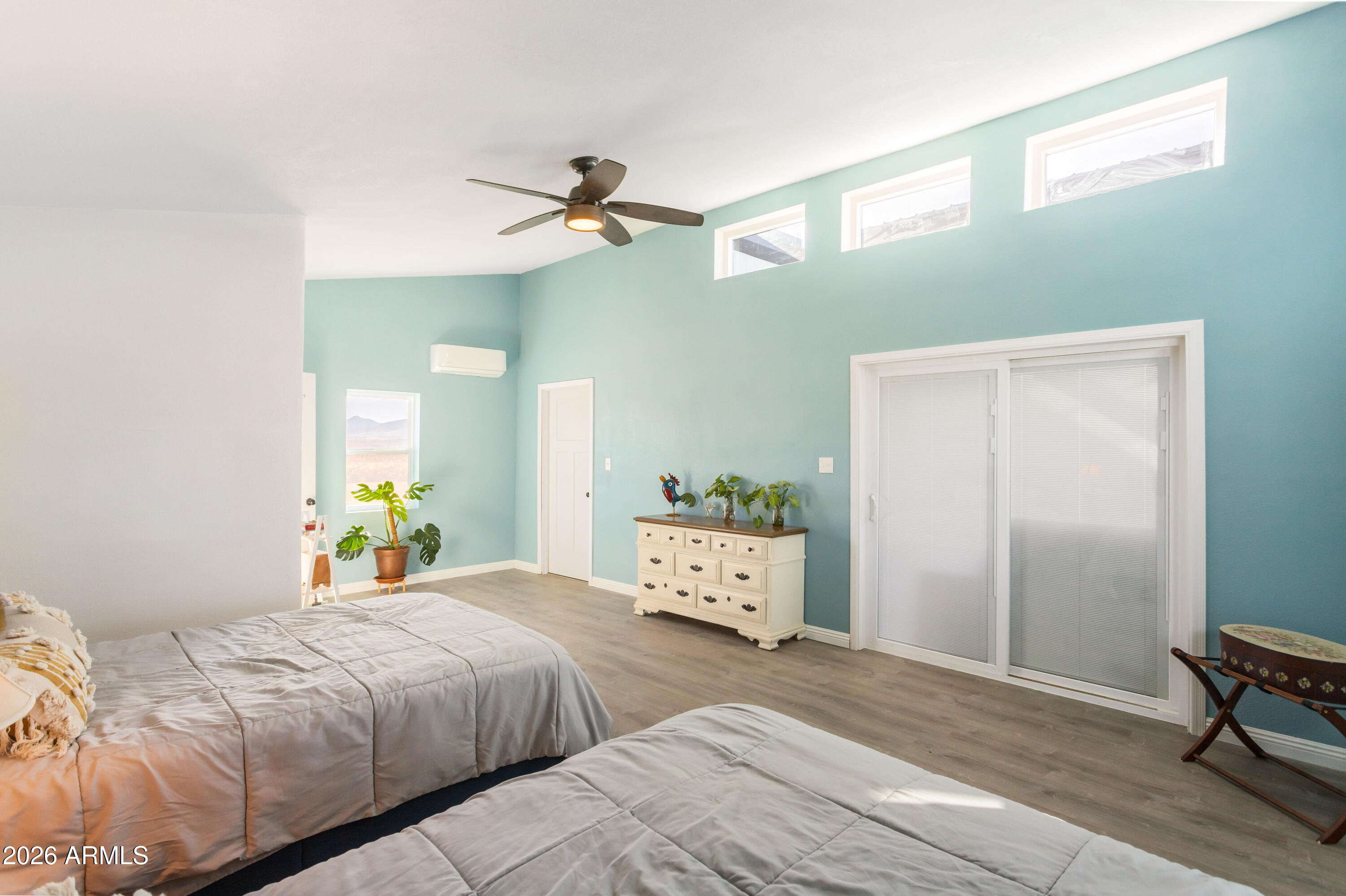 11441 South Samuel Road Hereford, AZ 85615 - Photo 31 of 47 a bedroom with a bed a dresser and a window