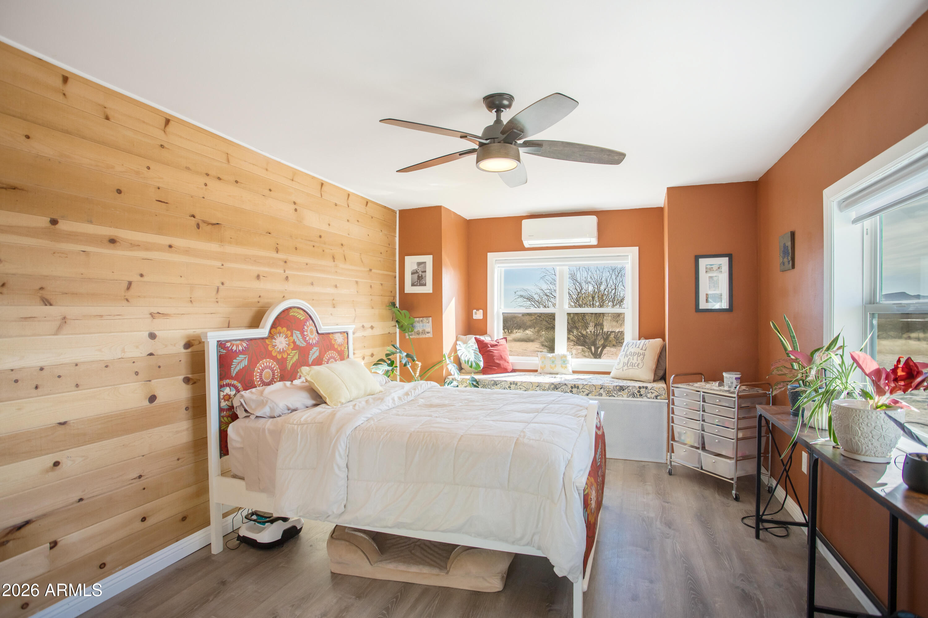 11441 South Samuel Road Hereford, AZ 85615 - Photo 34 of 47 a bedroom with a bed and wooden floor