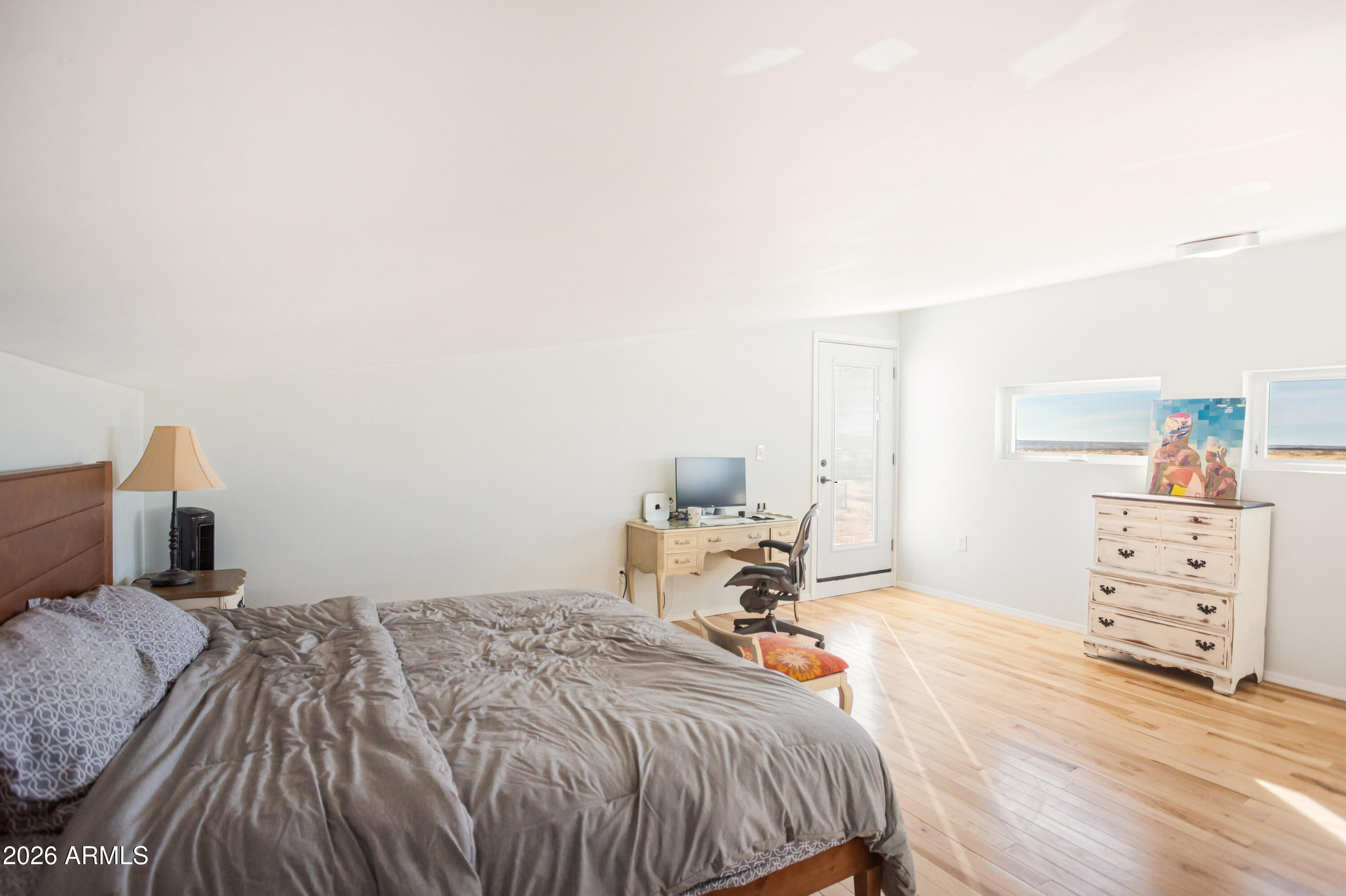 11441 South Samuel Road Hereford, AZ 85615 - Photo 41 of 47 a bedroom with a bed and wooden floor