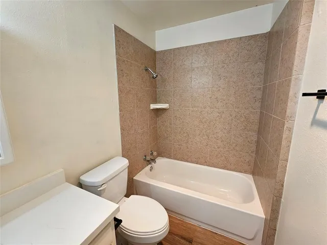 a bathroom with a toilet and a bath tub