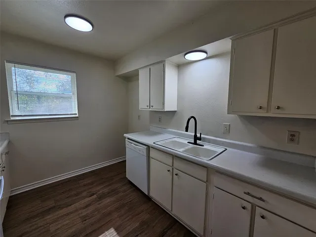 a kitchen with sink and cabinets