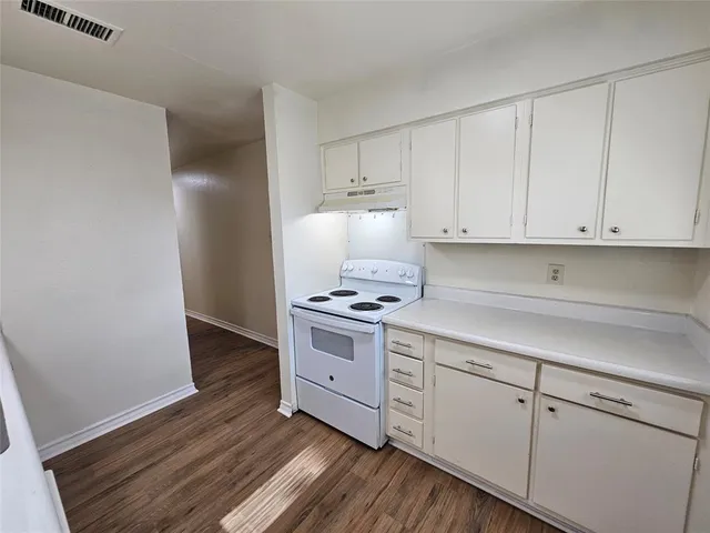 a kitchen with sink cabinets and stove top oven