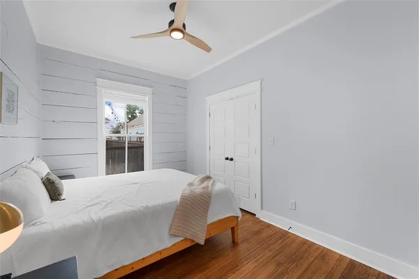 a bedroom with a bed and wooden floor