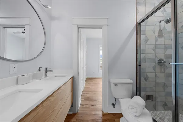 a bathroom with a sink a toilet and shower