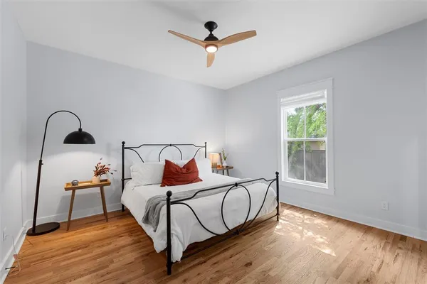 a bedroom with a bed and a window