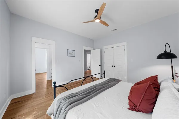 a bedroom with a bed and painting on the wall