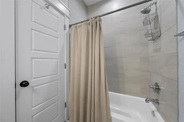 a bathroom with a shower and a tub