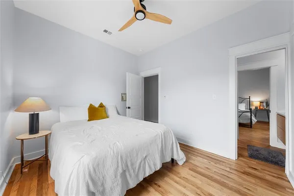 a bedroom with a bed and wooden floor