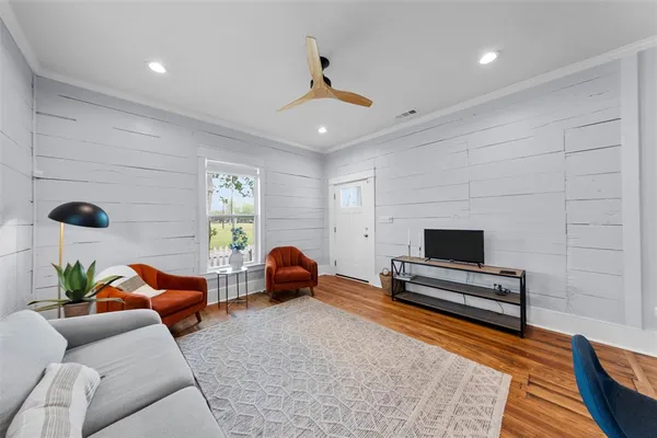 a living room with furniture and a flat screen tv