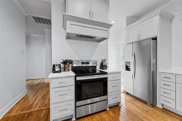 a kitchen with a stove and a refrigerator