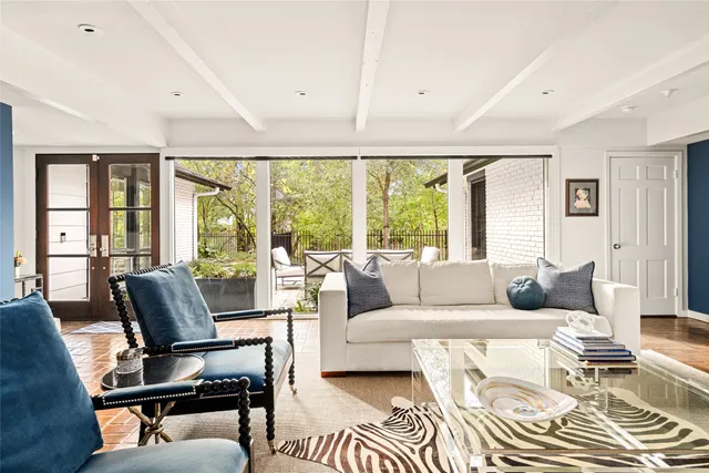 a living room with furniture and floor to ceiling windows