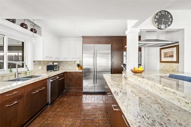 a large kitchen with a stove and a sink