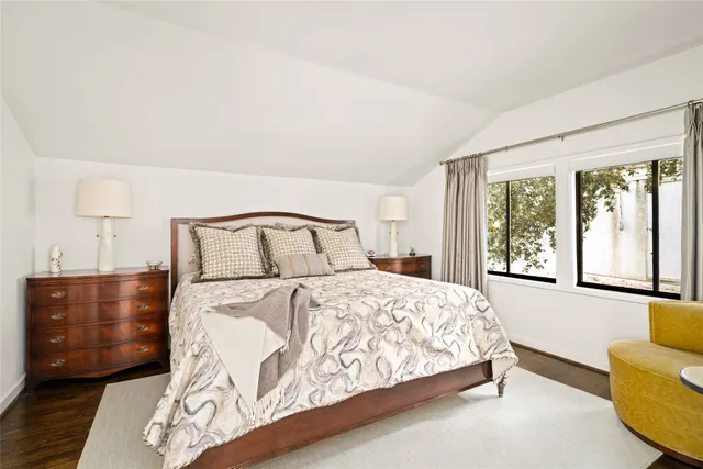 a living room with furniture a flat screen tv and kitchen view