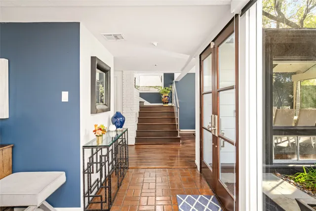 a living room with furniture a flat screen tv and a large window