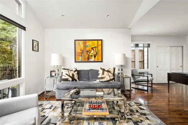 a living room with furniture fireplace and wooden floor