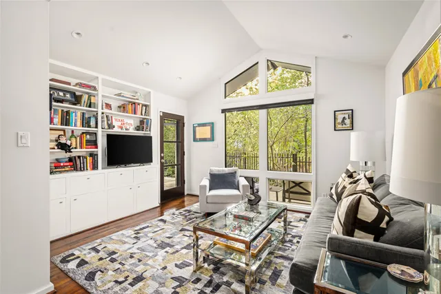 a view of a patio with couches table and chairs and potted plants