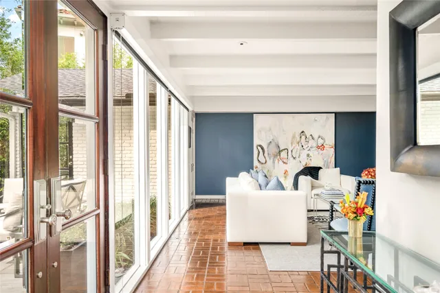 a living room with furniture and a floor to ceiling window
