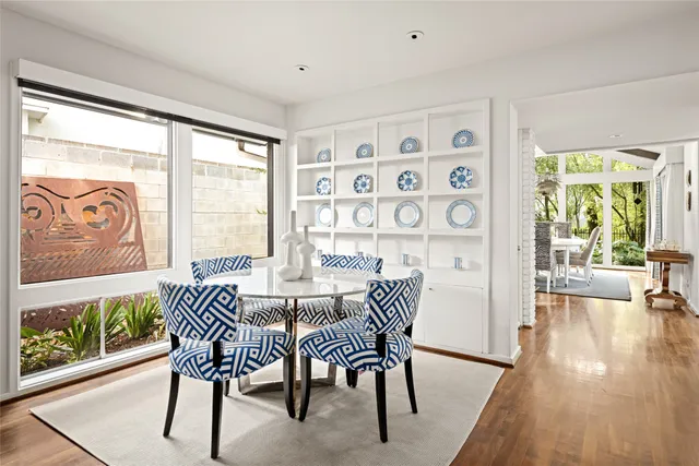 a dining room with furniture and wooden floor