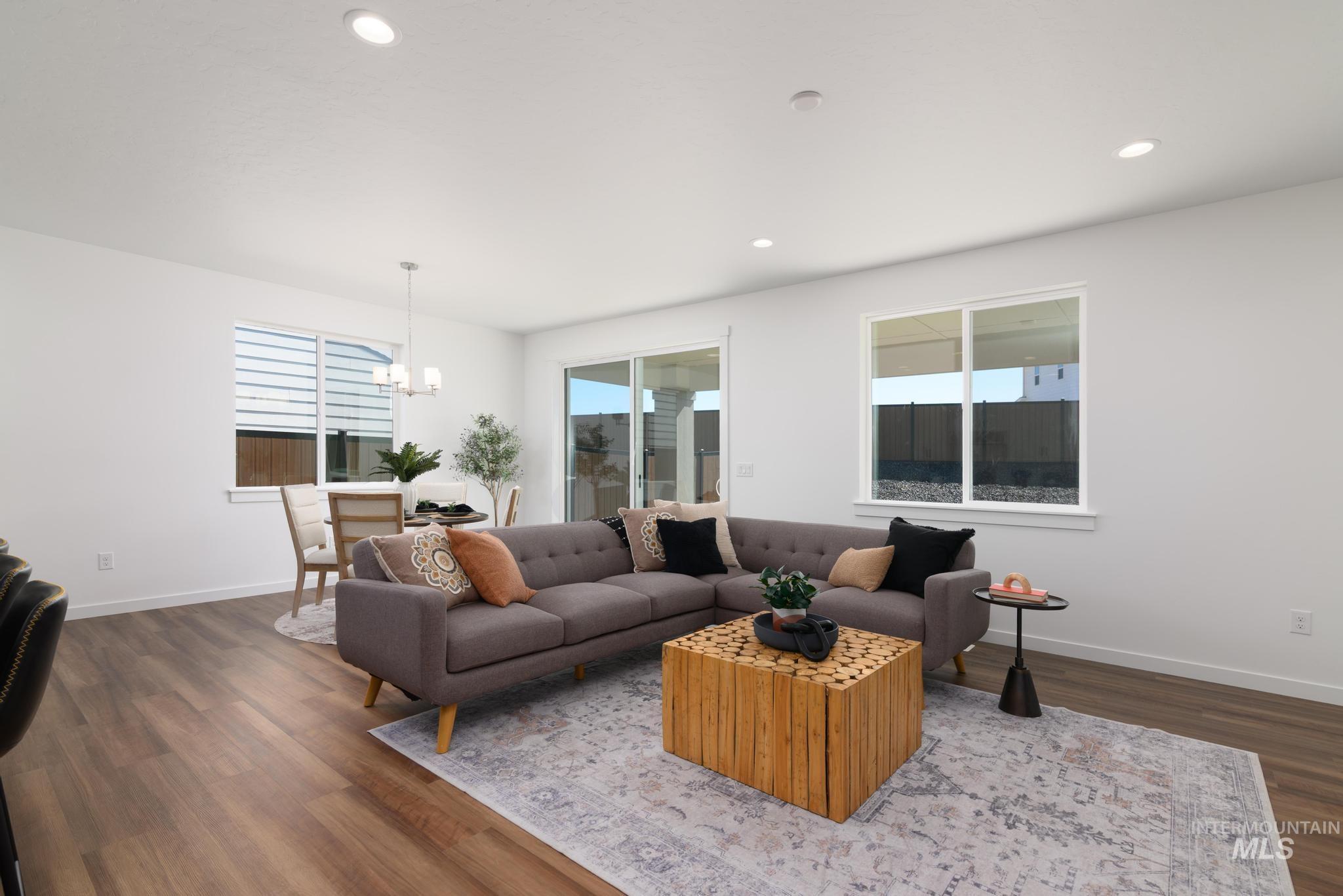 14829 Wing Spread Drive Caldwell, ID 83607 - Photo 2 of 10 Living area with a chandelier, dark wood finished floors, and recessed lighting
