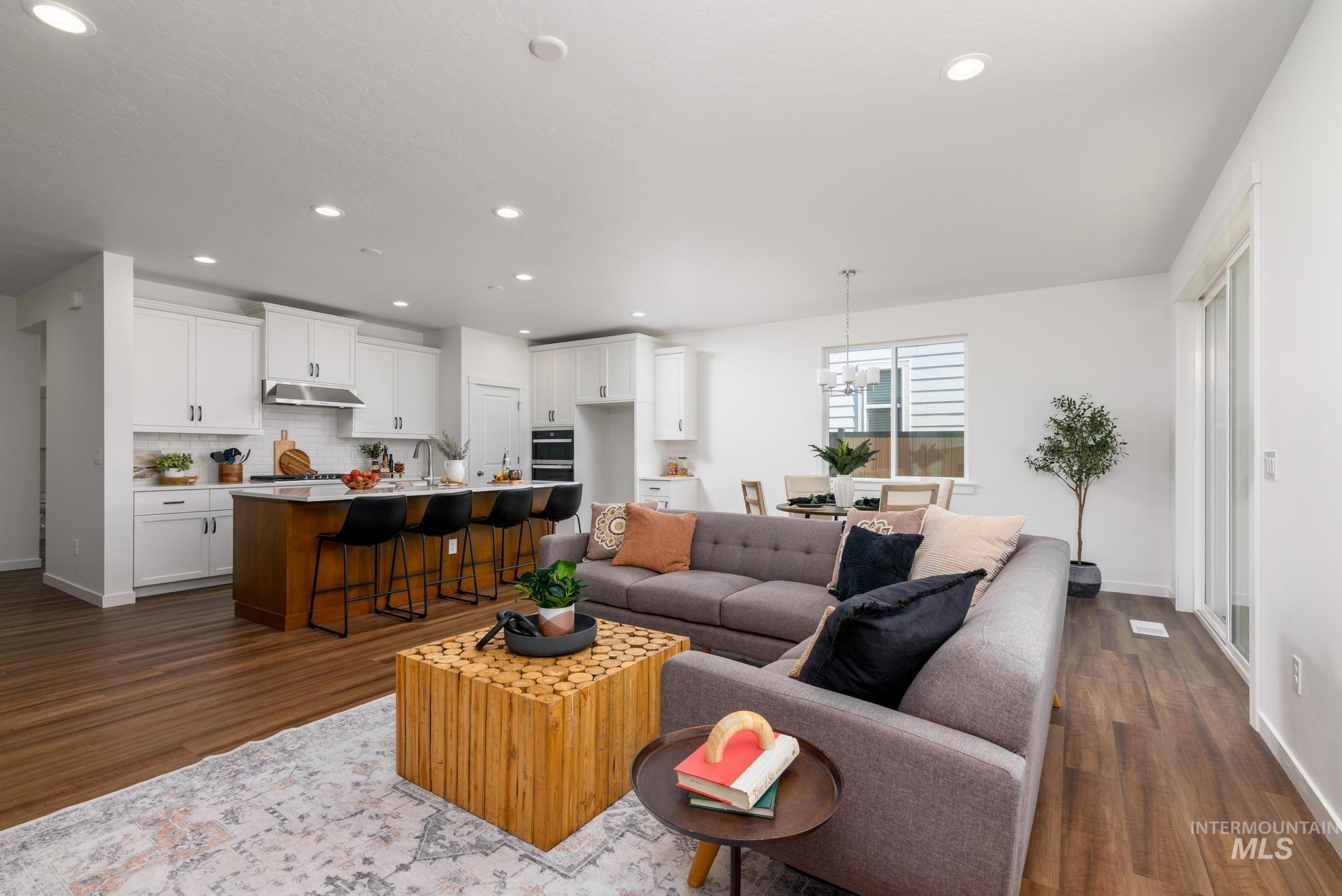 14829 Wing Spread Drive Caldwell, ID 83607 - Photo 3 of 10 Living room featuring dark wood-style flooring, recessed lighting, and a chandelier