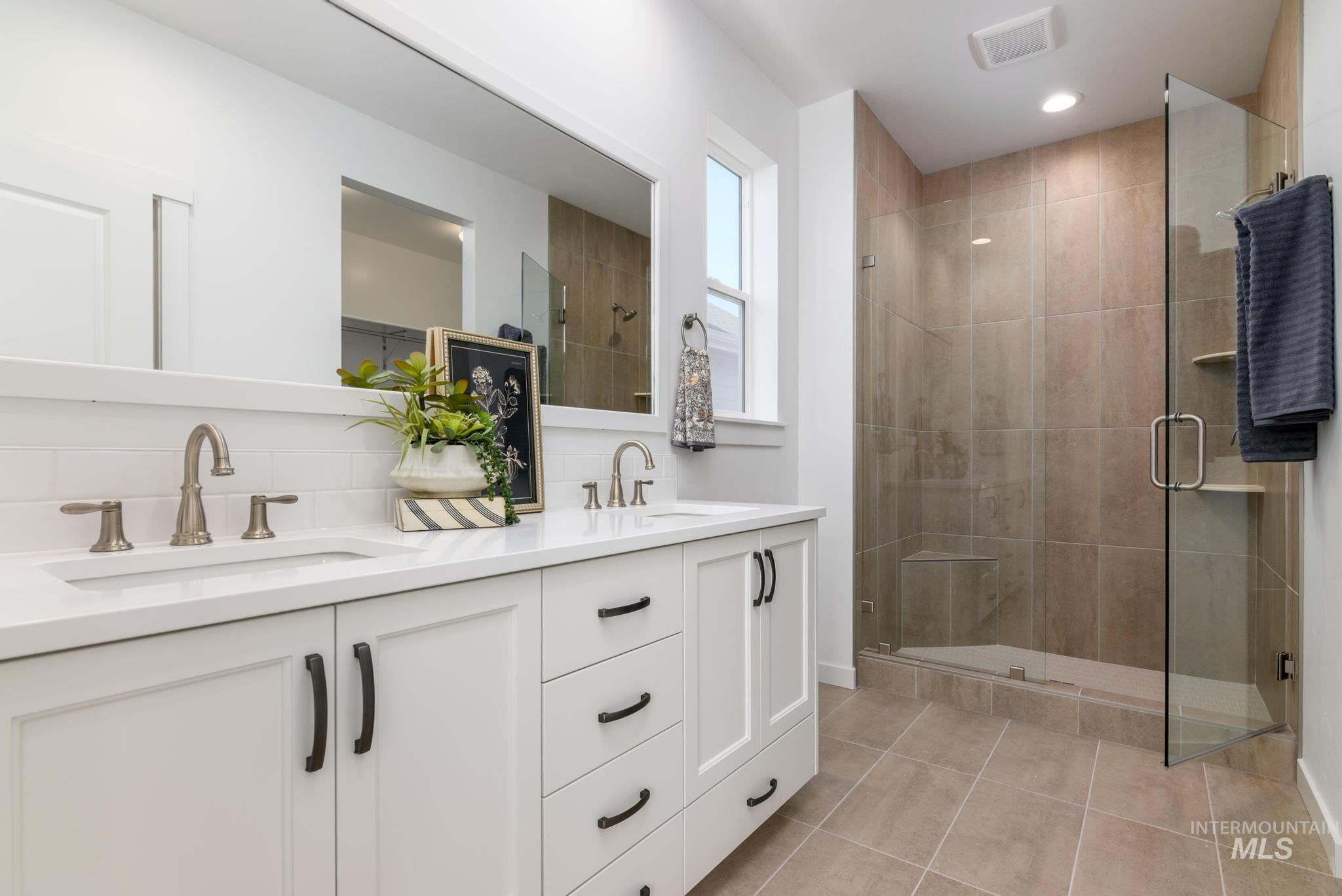 14829 Wing Spread Drive Caldwell, ID 83607 - Photo 8 of 10 Full bath featuring a shower stall, double vanity, and light tile patterned floors