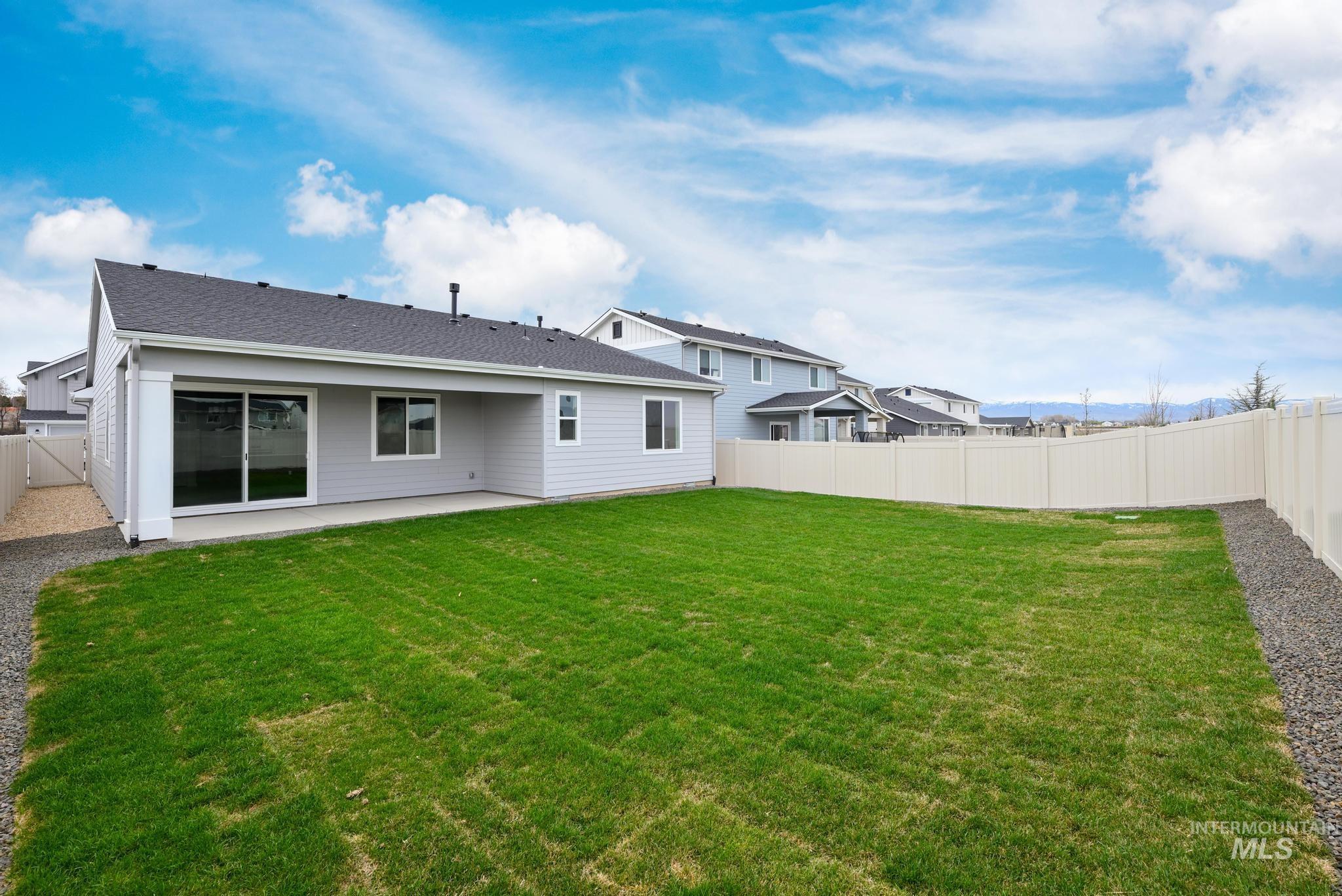 14829 Wing Spread Drive Caldwell, ID 83607 - Photo 10 of 10 Back of property featuring a fenced backyard, a patio area, and roof with shingles